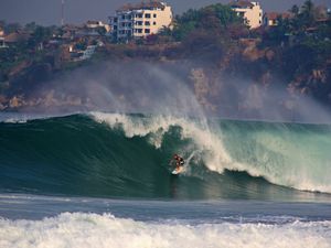 A surfer taking on a giant wave at Zicatela beach