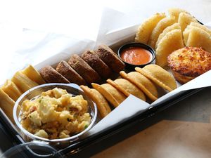 Basket of fried breads, fritters and yucca