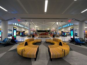 Round wood bench and play area in Newark's new terminal A 