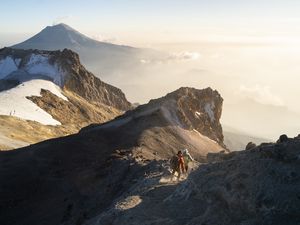A couple running down from the summit of Iztaccihuatl volcano