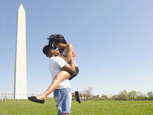 African American couple hugging near Washington Monument, Washington, DC