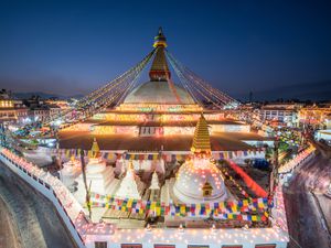 Boudhanath Buddhist monument lit up with colorful lights at night