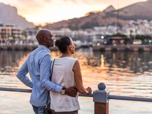 Black couple looking at sunset at Cape Town waterfront