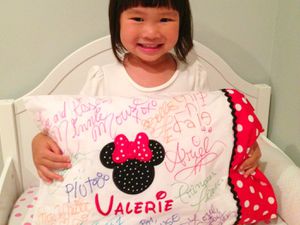 a little girl with a Disney pillowcase