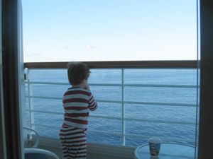 Little boy overlooking a cruise deck