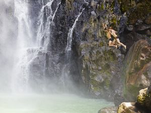 Dominica, Delices. Two people jump into the plunge pool at the foot of Victoria Fals.