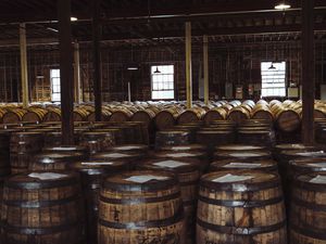 A warehouse fiilled with Whiskey barrels