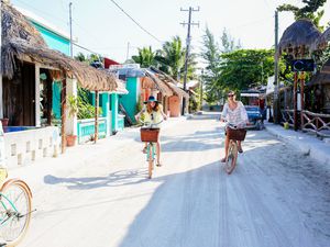 Family riding through small Mexican beach town