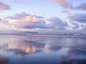 Clouds Reflect On An Oregon Beach At Sunrise in Hammond, Oregon