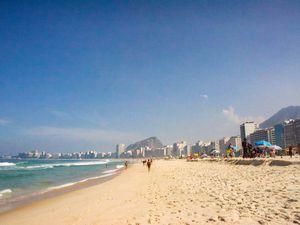Wide shot of Copacabana beach with the skyline and the mountain in the background