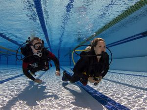 Scuba diving student and instructor practicing a skill