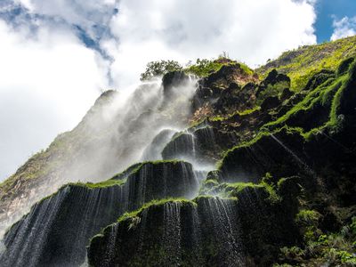 extreme low angle view of a waterfall tricking over the side of a cliff in Sumidero Canyon