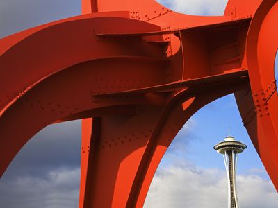 View of the Seattle Space Needle through a large, red, metal sculpture