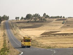 A bus traveling down an empty road in Ethiopia