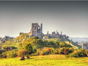 View of Corfe Castle in Dorset, surrounded by rural farmland