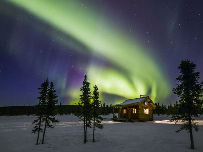 Northern Lights over rustic cabin in Alaska