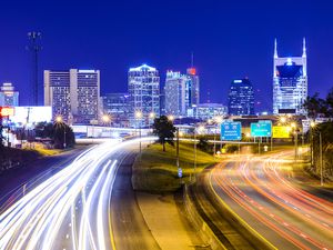 Long exposure of a Nashville highway at night with the skyline in the background