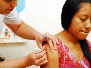 Guatemala, Salama, nurse vaccinating teenager