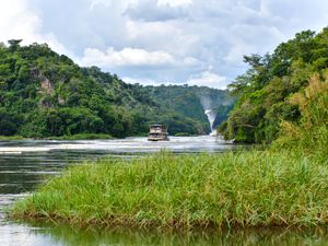 River boat on the Victoria Nile with Murchison Falls in the background
