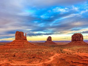 Three large rock formations in Monument Valley just before sunset