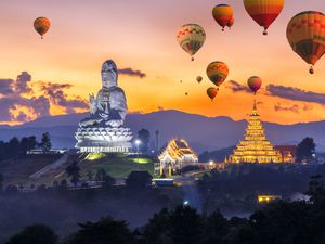 Colorful hot air balloons flying over Wat Huay Pla Kang, Chinese temple in Chiang Rai Province, Thailand