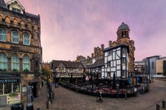 Pastel skies over the historical architecture of Shambles Square in the middle of the city of Manchester, UK.