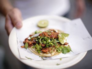 Taco being served from a street vendor in Mexico City, Mexico