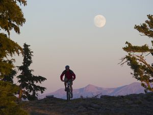 A man bikes beneath the full moon above Lake Tahoe in California.