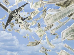 $100 bills falling from an airplane in a blue sky with clouds