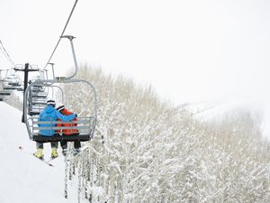 Couple riding ski lift