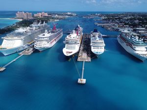 High Angle View Of Cruise Ships Moored In Sea Against Blue Sky
