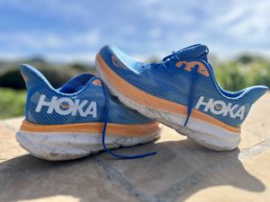 Closeup of Hoka Clifton 9 shoes displayed on a table outdoors