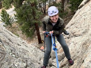 Author rappelling down a rock face