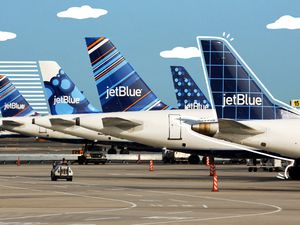 Designs on JetBlue planes with illustrated lines and clouds
