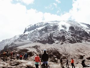 Hikers looking up at Mt Kilimanjaro