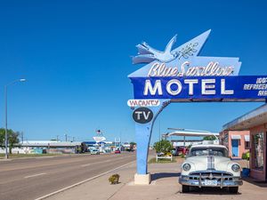 Motel Blue Swallow next to route 66 and an antique pontiac car parked at the entrance. Tucumcari, New Mexico, US.
