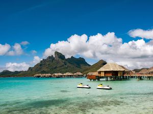 View of mountains and overwater bungalows in Bora Bora