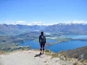 Woman standing on top of Roy's Peak in New Zealand