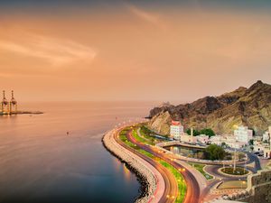 Panoramic View of a cruving seaside road in Muscat, Oman at sunset