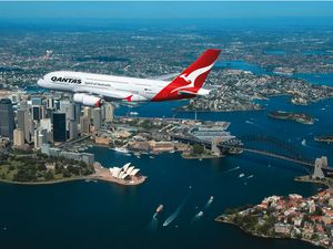 A Qantas Airbus A380 flying over Sydney Harbor