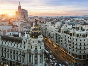 Skyline of Madrid with Buildings and a busy street at sunsent