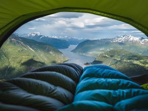 two sleeping bags in doorway of a tent with a view of Norwegian fiords