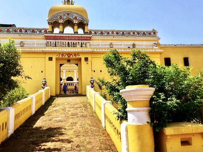 walkway into a yellow palace in Odisha.