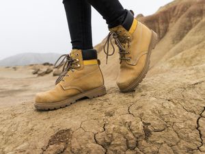 Spain, Navarra, Bardenas Reales, hiking shoes of young woman in nature park, close-up