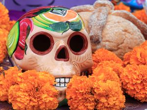 Sugar skull and pan de muerto at Day of the Dead altar