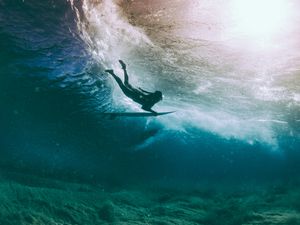 Surfer duck diving under a wave, Hawaii, America, USA