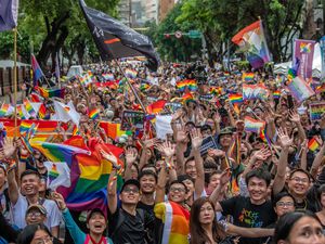 Marchers in Taipei waving pride flags