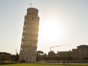 The Leaning Tower of Pisa with the sun setting behind it