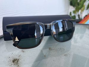 Warby Parker Barkley sunglasses displayed with case on a glass table