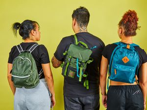 Three people wearing different mini backpacks we recommend displayed on a green background
